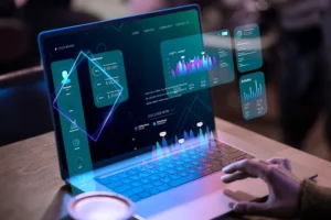 Person interacting with a futuristic laptop displaying IT Tech digital dashboards, graphs, and data analytics for tech projects.