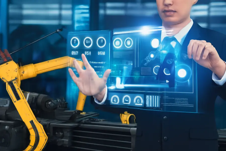 Professional interacting with a futuristic holographic interface displaying automation controls and robotic arm data in an industrial factory setting.