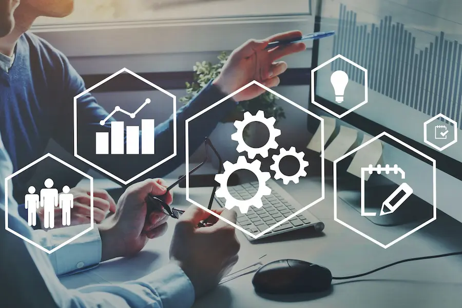 Team of diverse professionals using automation services with AI-powered tools, cloud storage solutions, and digital workflows in a modern office.