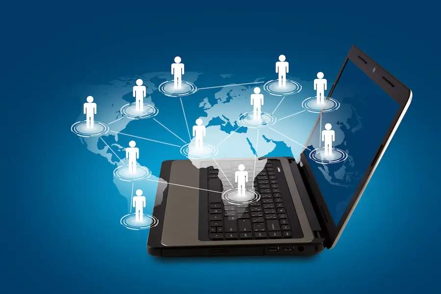 Global networking concept showing connected people via laptop representing multi-tech solutions, digital connectivity, and global collaboration.