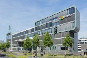 Microsoft office building with logo, reflecting company growth and strategic changes such as Microsoft layoffs.