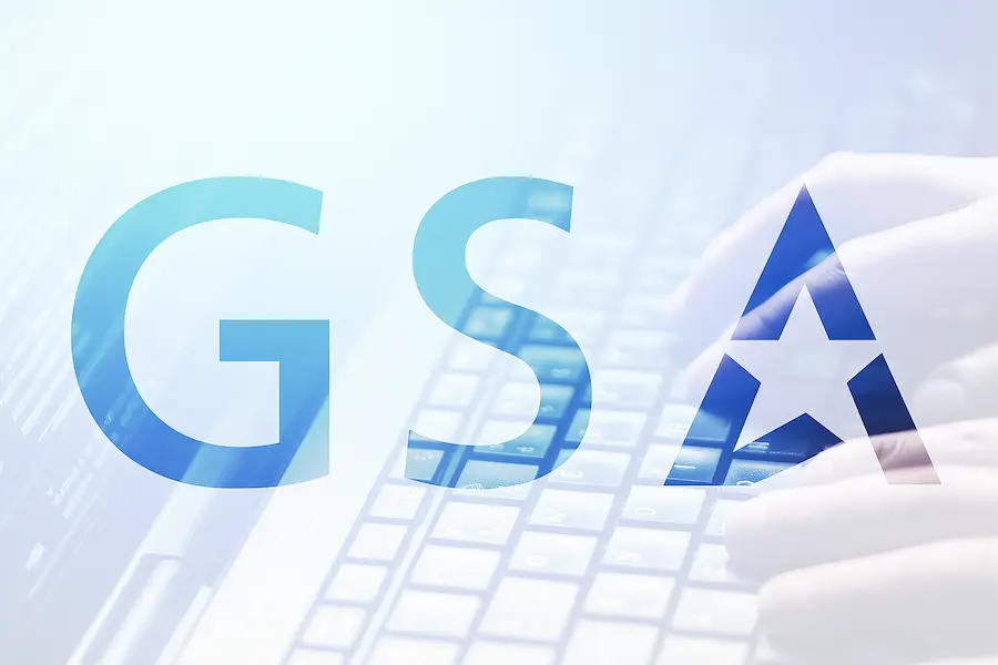 GSA AI tools concept showing hands typing on a keyboard with transparent GSA logo overlay, symbolizing federal adoption of artificial intelligence solutions.